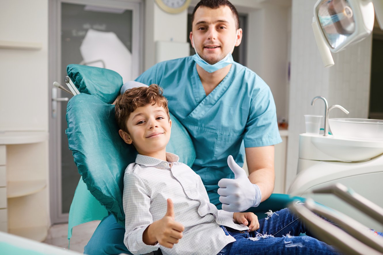 Happy Dentist and Child Raised Their Thumb